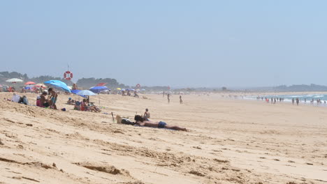 People-enjoying-beach-on-sunny-day-during-pandemic-period
