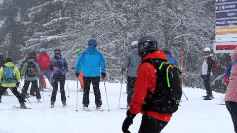 People-with-skis-at-ski-resort.-Handheld,-slomo