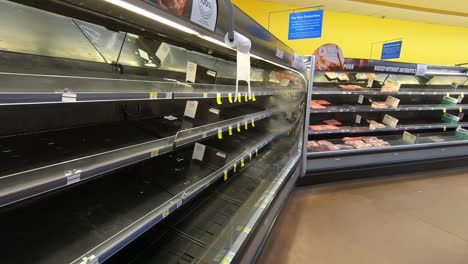 A-woman-gets-frustrated-with-the-completely-empty-meat-section-of-a-local-supermarket-in-Ottawa,-Ontario-Canada-during-the-COVID-19-coronavirus-outbreak