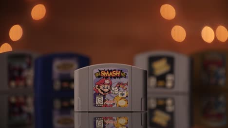Super-Smash-Bros-cartridge-being-set-in-frame-with-other-N64-games-in-the-background