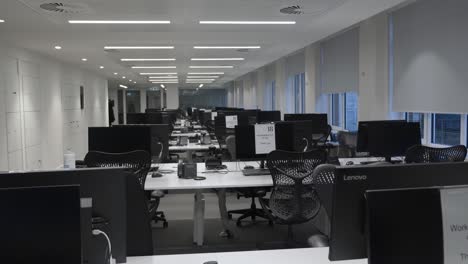 Rows-Of-Empty-Desks-And-Chairs-In-Office-Building-During-Lockdown