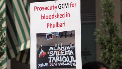 A-placard-says-“Prosecute-GCM-for-bloodshed-in-Phulbari”-on-a-protest-marking-the-14th-anniversary-of-three-killed-during-demonstrations-in-Phulbari,-Bangladesh
