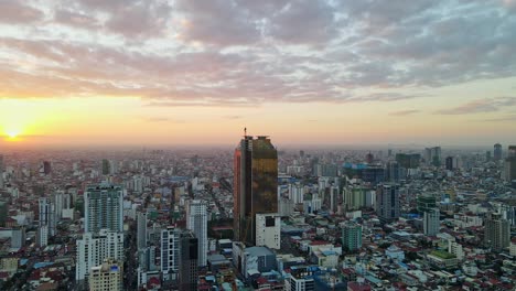 Golden-Tower-42-Surrounded-By-High-rise-Buildings-At-Sunset-In-Phnom-Penh,-Cambodia