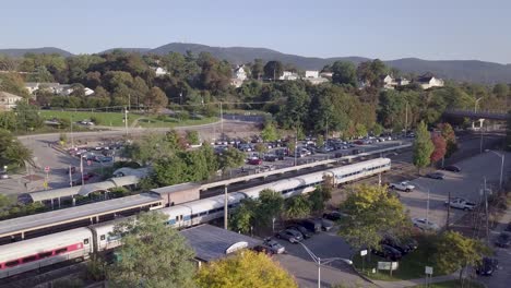 Aerial-footage-of-a-MetroNorth-train-leaving-Beacon,-New-York-in-the-Hudson-Valley