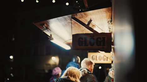 People-purchasing-Glögi-a-traditional-Finnish-mulled-wine-in-the-Christmas-Market-in-Tallinn,-Estonia