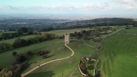 Wide-aerial-view-of-Broadway-tower,-an-English-landmark-stood-atop-Beacon-Hill-in-the-Cotswolds,-UK