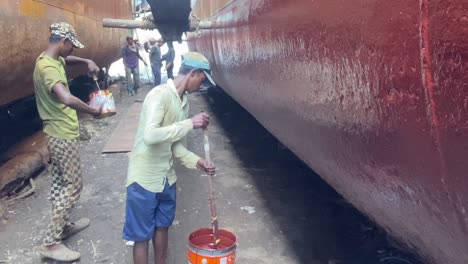 Labor-is-hard-work,-and-these-working-people-know-it-well-as-they-paint-the-hull-of-a-ship-with-precision-and-skill