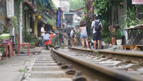 Busy-Train-Street-with-tourists-and-locals-in-famous-Old-Quarter-in-Hanoi,-Vietnam