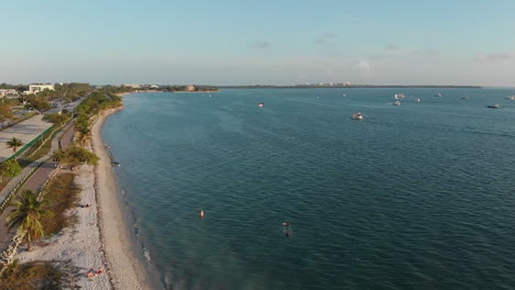 Stunning-establisher-aerial-view-of-long-shoreline-of-Playita-beach,-Miami