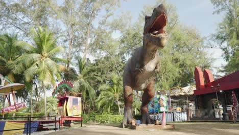 Dinosaur-statue-opening-its-mouth-at-an-amusement-park-in-Bagan-Lalang