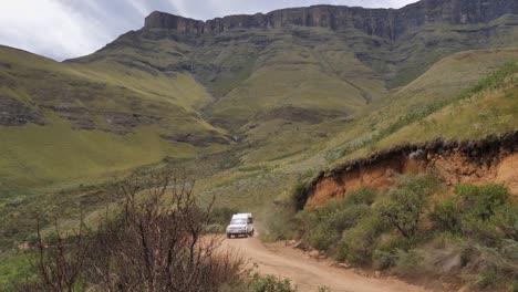 Rugged-tourism-vehicles-take-tourists-up-rough-dirt-road-of-Sani-Pass