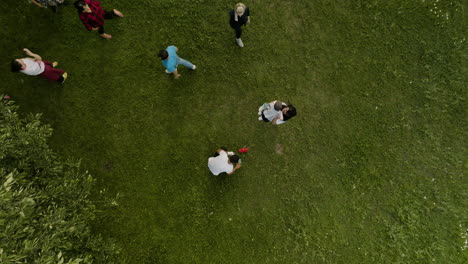 Aerial-View-of-Families-Playing-on-a-Green-Lawn-Together,-Illustrating-Family-Bonding