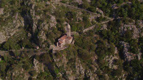 Church-of-Our-Lady-of-Remedy-on-mountain-slope-above-Kotor,-aerial