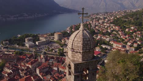 Bell-tower-of-Church-of-Our-Lady-Remedy-with-holy-cross,-Kotor-in-background