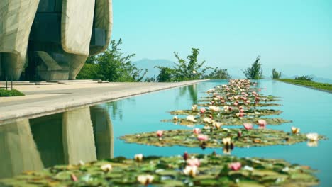 Long-lagoon-full-of-lotuses-and-the-Bahai-Temple-of-South-America-in-Santiago,-Chile
