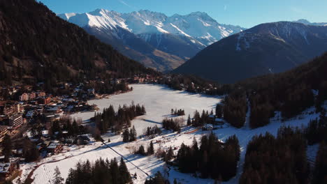 Aerial-flight-over-the-winter-landsacape-at-lake-lac-champex-in-the-swiss-alpes-near-mount-blanc