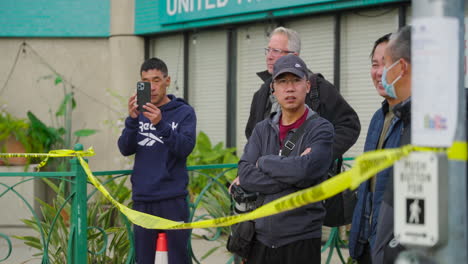 A-Crowd-of-Asian-People-Stand-Behind-Caution-Tape-After-the-Monterey-Park-Shooting