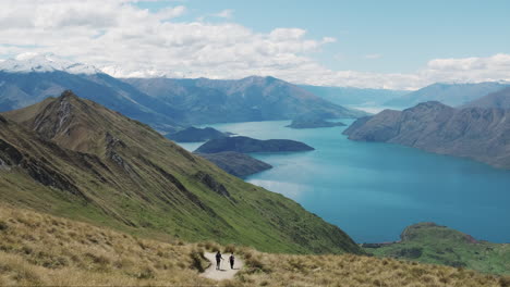 Slow-pan-of-tourists-hiking-Roys-Peak-track-in-New-Zealand