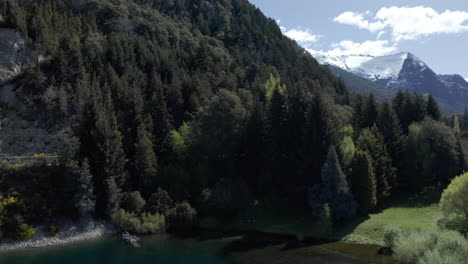 AERIAL---Forest-and-Colonia-Suiza,-Moreno-Lake-near-Bariloche,-Rio-Negro,-Argentina,-pan-right