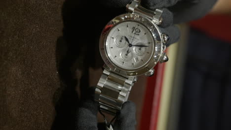 Person-inspecting-luxury-expensive-watch,-close-up-slow-motion-view