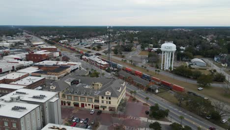 Waycross-Georgia-and-Train-Stopped-at-Station-Aerial-View-Tracking-Right-Wide