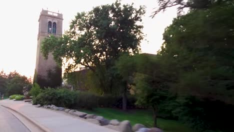 Driving-past-Carillon-Tower-on-the-University-of-Wisconsin--Madison-campus-at-sunset