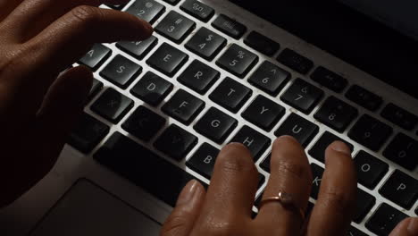 A-close-up-shot-of-a-woman-typing-on-her-laptop-as-she-works-from-home