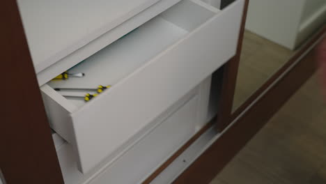 Man-Opens-Drawer-And-Grab-The-Tools