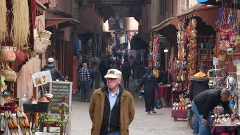 People-walking-in-a-shopping-street-in-Morocco,-Marrakesh,-Medina