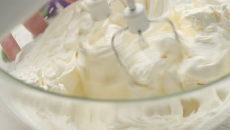 Close-up-shot-of-mixing-whipped-heavy-cream-with-mascarpone-cheese,-dipping-twisters-in-cream