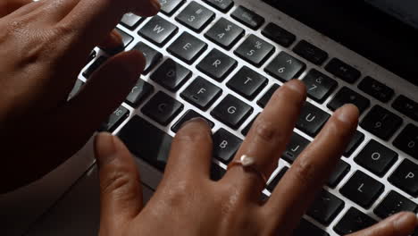A-tight-angle-of-an-asian-woman-typing-on-a-computer-laptop-keyboard