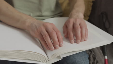 Close-up-view-of-man-hands-touching-a-book