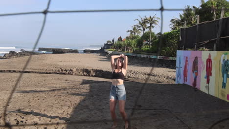 Sportswoman-playing-beach-volleyballball.