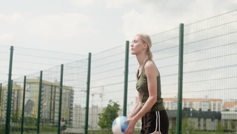 Side-view-of-blonde-woman-hitting-a-volleyball