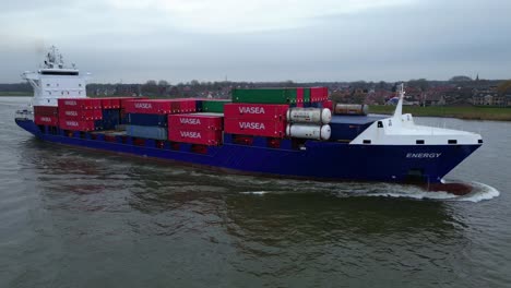Aerial-View-Of-Starboard-Energy-Cargo-Ship-Carrying-Viasea-Intermodal-Containers-Passing-Along-Oude-Maas
