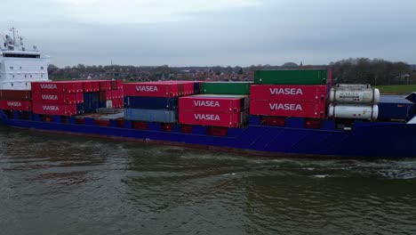 Aerial-View-Of-Starboard-Energy-Cargo-Ship-Carrying-Viasea-Intermodal-Containers-Passing-Along-Oude-Maas