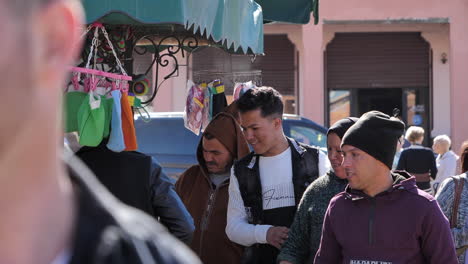 Muslim-family-browsing-Marrakesh-street-vendor-stalls-in-bustling-Moroccan-market