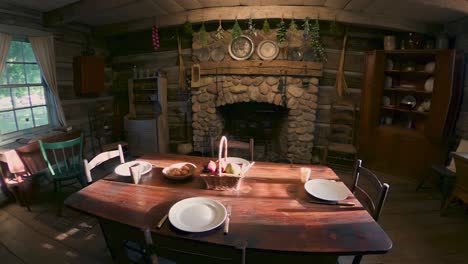 Main-floor-hearth-and-table-of-the-cabin-at-the-Historic-site-at-the-Peter-Whitmer-Farm-location-in-New-York-in-Seneca-County-near-Waterloo-Mormon-or-The-Church-of-Jesus-Christ-of-Latter-day-Saints