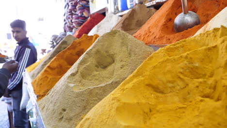 Colourful-Moroccan-spices-piled-in-Marrakesh-market-stall,-Jemaa-El-Fnaa,-Close-up-slow-motion