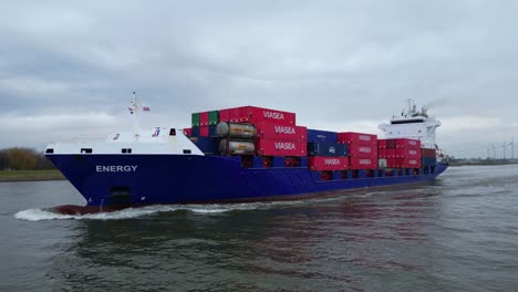 Aerial-Off-Port-Side-Of-Energy-Cargo-Ship-Carrying-Viasea-Intermodal-Containers-Passing-Along-Oude-Maas