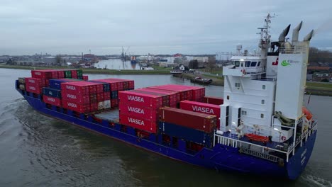 -Energy-Cargo-Ship-Carrying-Viasea-Intermodal-Containers-Passing-Along-Oude-Maas-On-Cloudy-Day