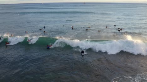 Bodyboarders-catch-waves-with-whitewash-trailing-behind-in-Hawaii