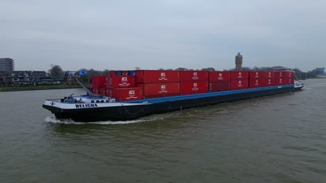 Belicha-Cargo-Ship-Loaded-With-Containers-Near-Dordrecht-City,-South-Holland,-Netherlands
