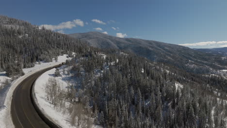 Aerial-Orbiting-shot-of-a-mountain-road-outside-of-steamboat-Springs
