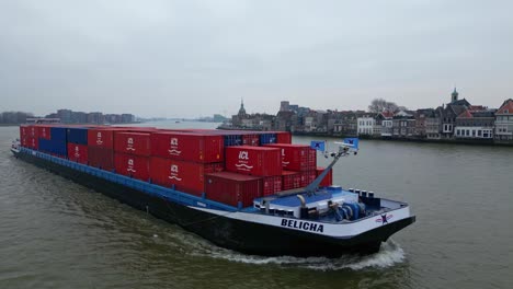 Drone-Tracking-Shot-Off-Starboard-Side-Of-Belicha-Inland-Freighter-Transporting-Intermodal-Containers-Along-Oude-Maas