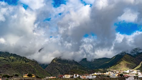 Time-Lapse-Over-A-Mountain-Village-With-Fluffy-White-Clouds-Swirling-Around