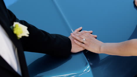 Couples-hands-on-blue-car