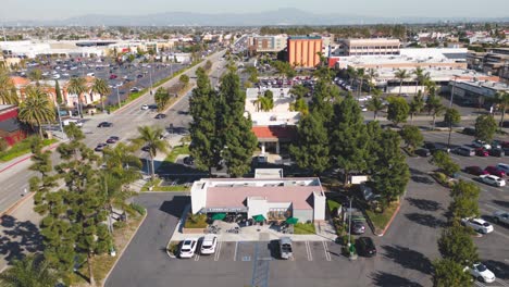 A-sunny-day-at-Starbucks-in-SoCal-captured-in-an-aerial-time-lapse:-customers-in-out,-drive-thru-busy,-perfect-weather