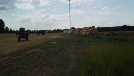 Flight-through-hay-bales-towards-an-abandoned-trailer-in-the-middle-of-a-field