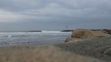 Waves-crashing-on-jetty-in-Oceanside-California-on-an-overcast-day